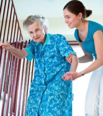 caregiver assisting client in walking