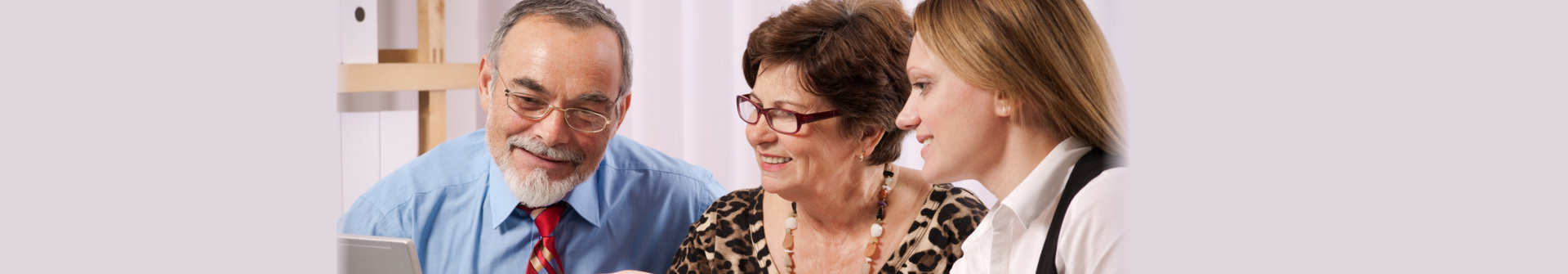 seniors and a woman using laptop