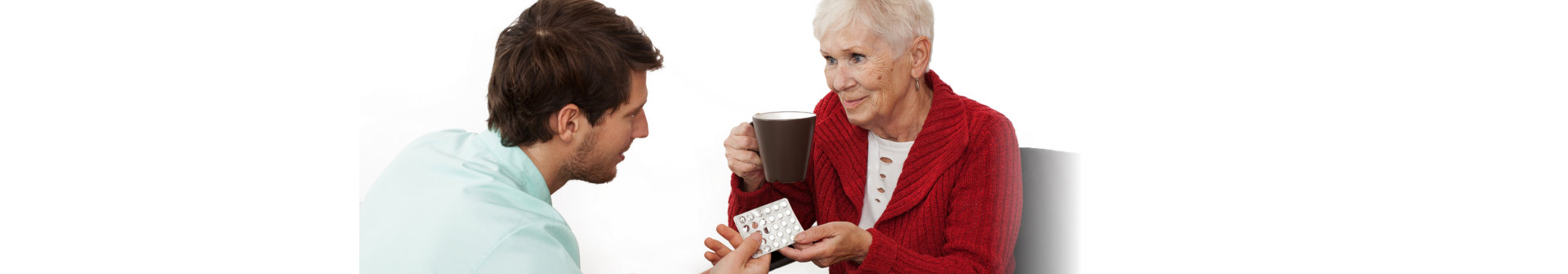 caregiver giving medicines to patient