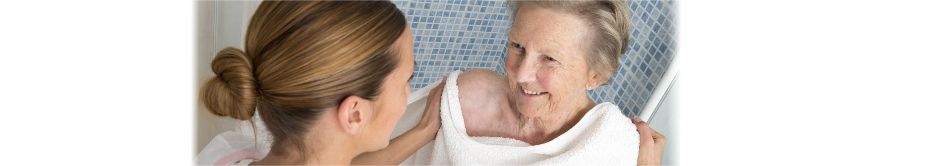 caregiver assisting the senior woman in bathing